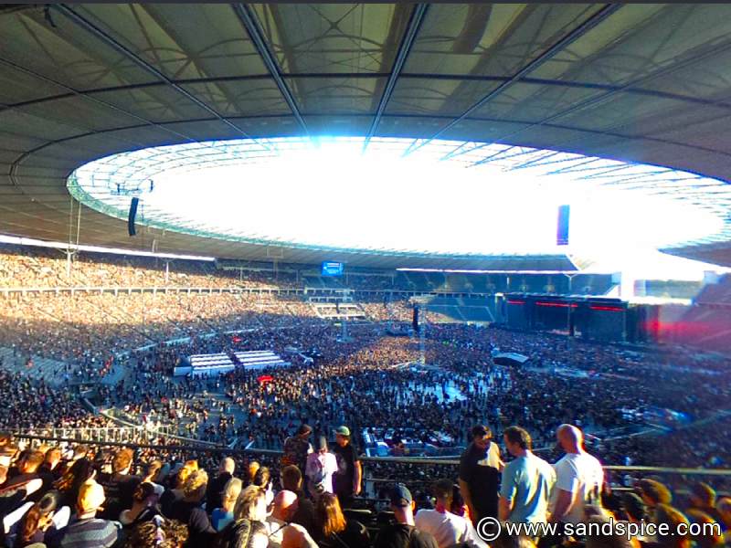 Panoramic view of a packed Berlin Olympiastadion during a large-scale System of a Down concert from the tiered seating area.