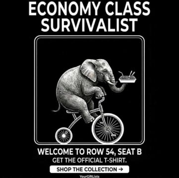 High-definition T-shirt design featuring a witty illustration of a large elephant balancing a meal tray while riding a tiny tricycle, with the text 'Economy Class Survivalist' in bold white letters on a black background.